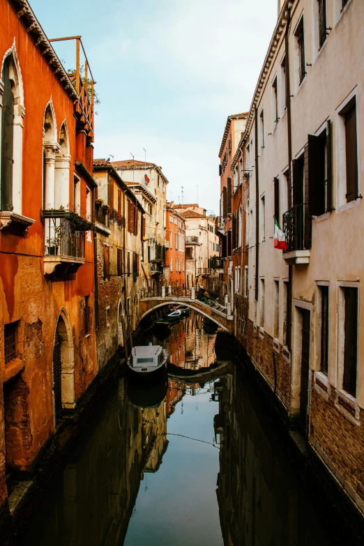 a waterway runs between the buildings along side of it