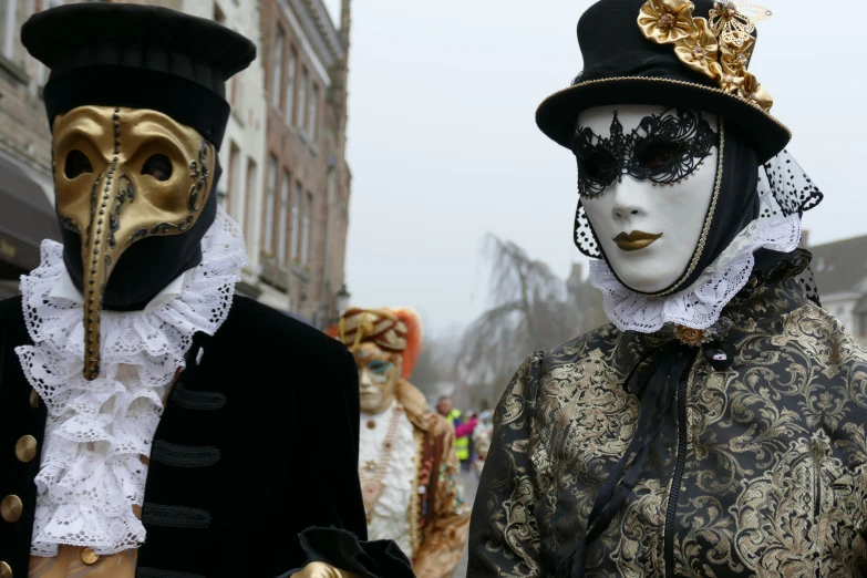 two costumes with gold accents, one black, one gold