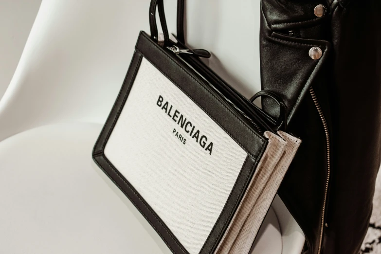 a white, black and beige bag hanging on the wall