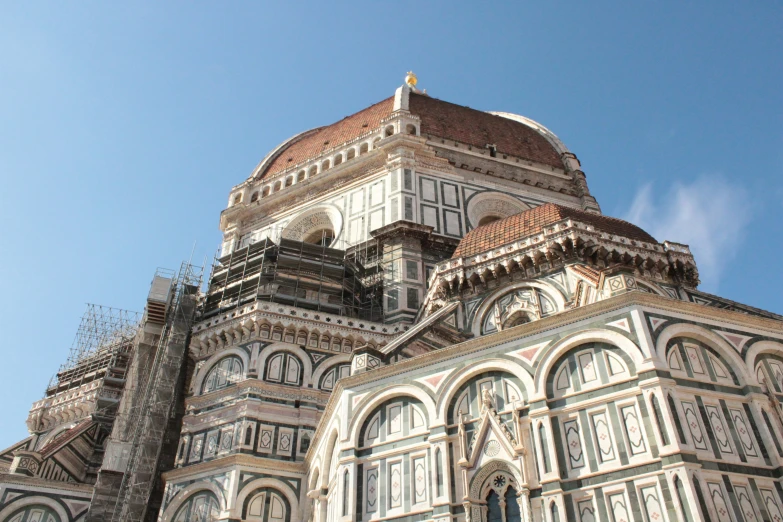 a close up of the side of a cathedral with scaffolding on top