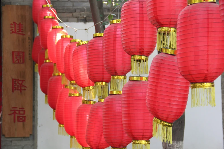 there are many red and gold lanterns hanging