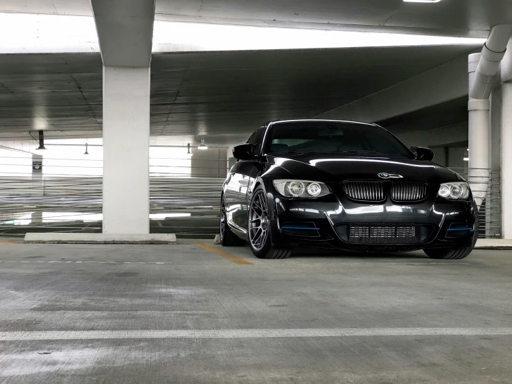 a bmw is parked in an empty parking garage