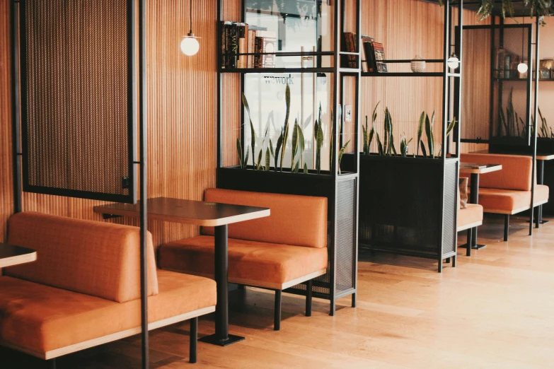 a restaurant with orange upholstered booth seats and tables