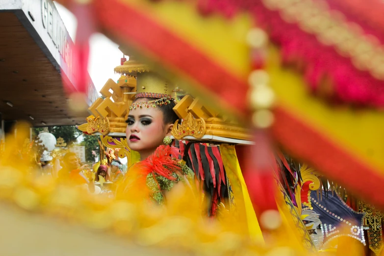 an oriental woman with colorful make up and headpiece
