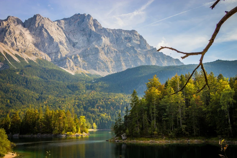 a mountain scene with a small lake and trees