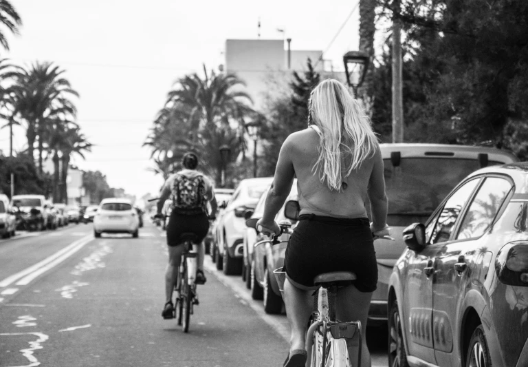 there is a man riding his bicycle next to a woman on her bike