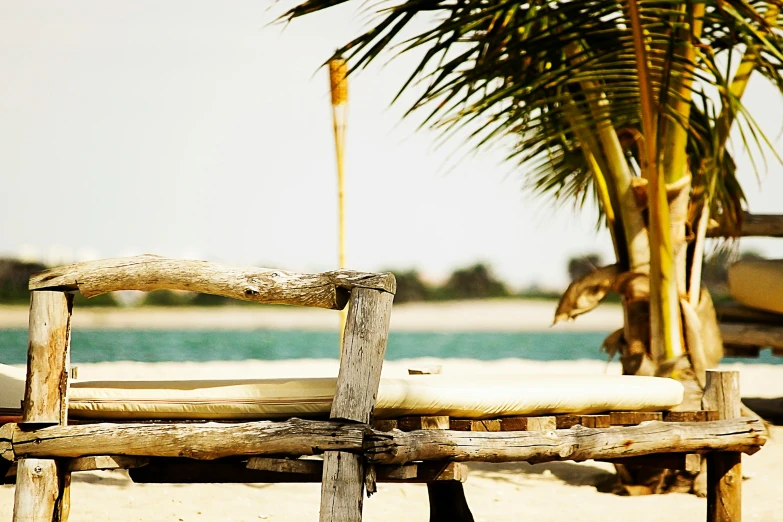 a lone beach chair sits on the sand