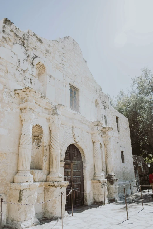 two people stand in front of an old building