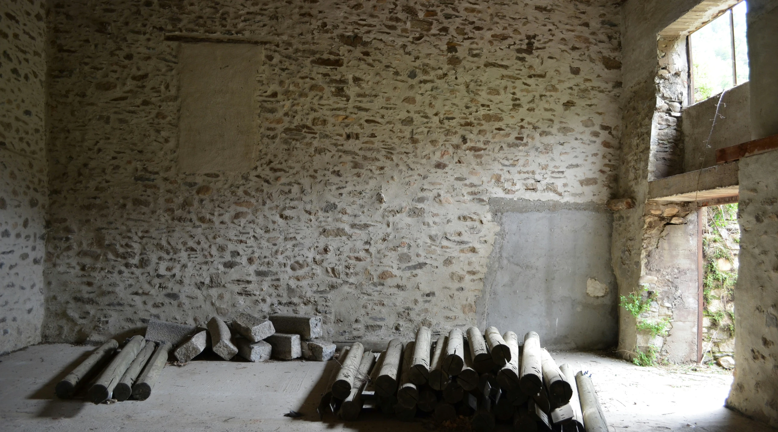 an old room with lots of wood logs