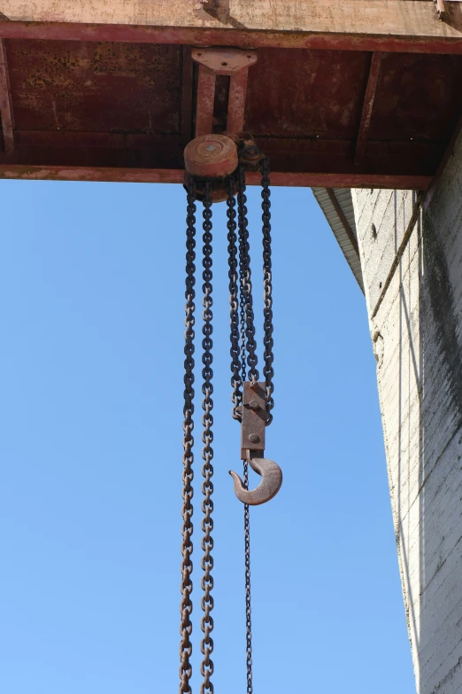 two chains are hanging down from a beam