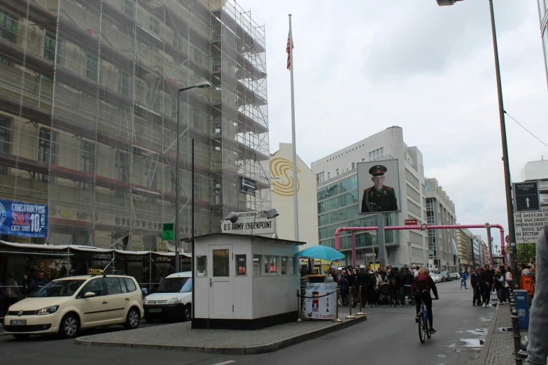 the car is traveling past the large billboard of a man