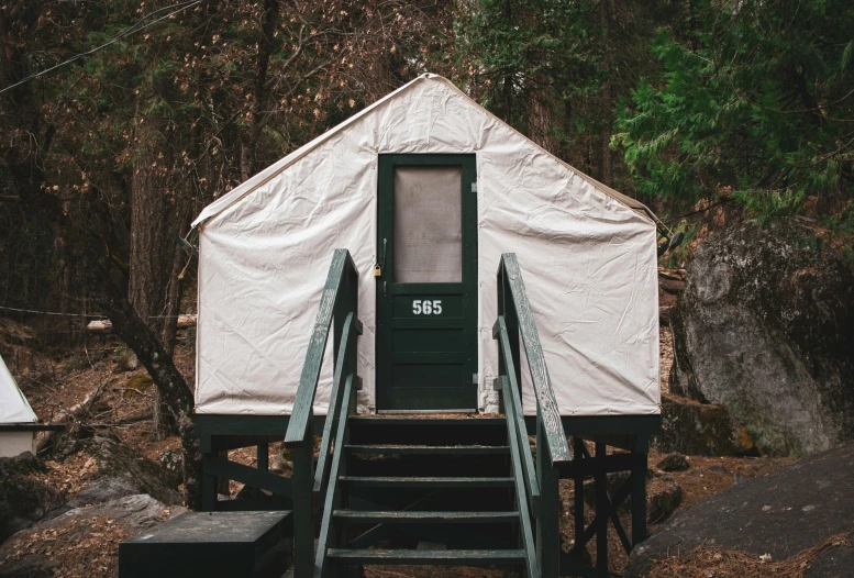 a set of stairs leading up to a white outhouse