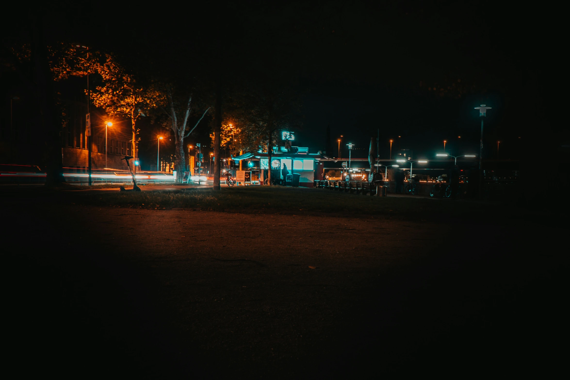 a night view of street lights and a blue shed