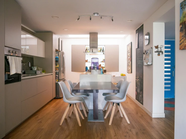 a table sitting in a kitchen next to some chairs