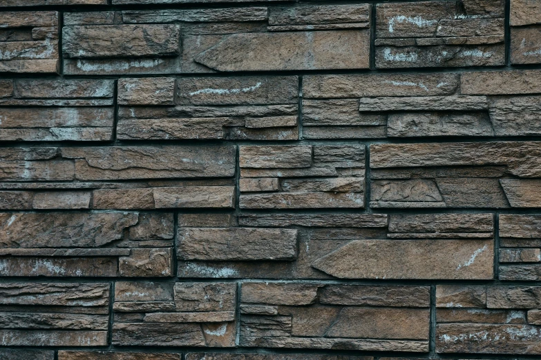 brick wall of different sizes and colors with small s
