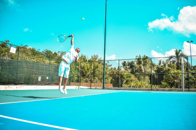 a tennis player is swinging his racket at the ball