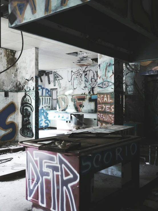 an empty pool surrounded by graffiti and other graffiti covered walls
