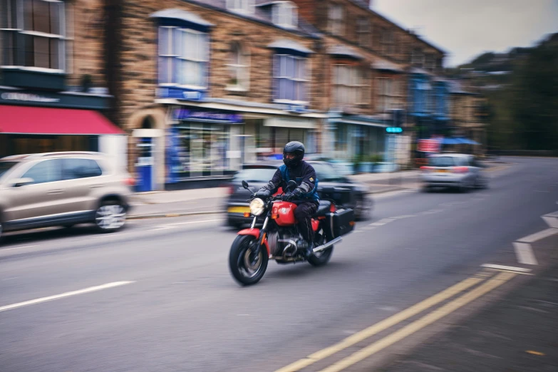 man riding a motorcycle in the street with other vehicles