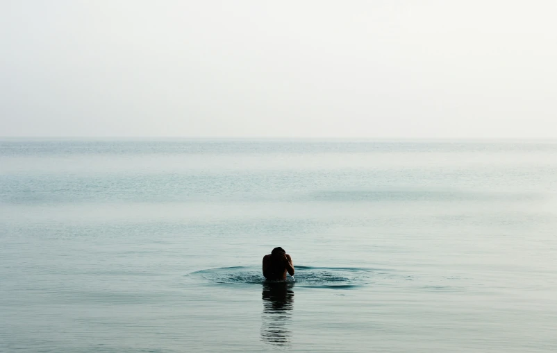 a person swimming in the water at the beach