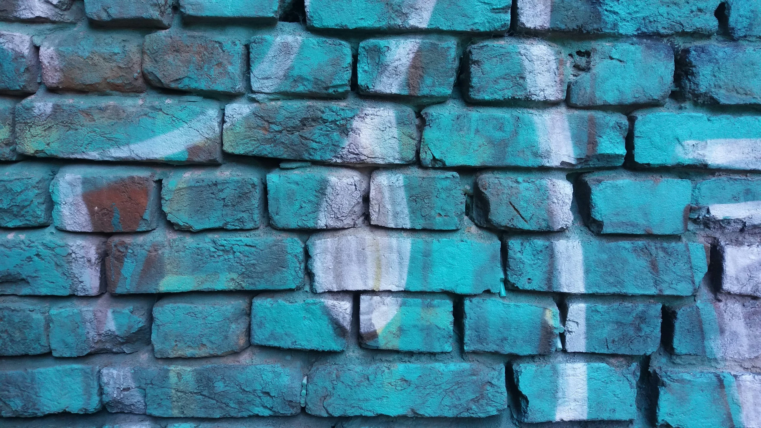 a brick wall with many tiles all over it