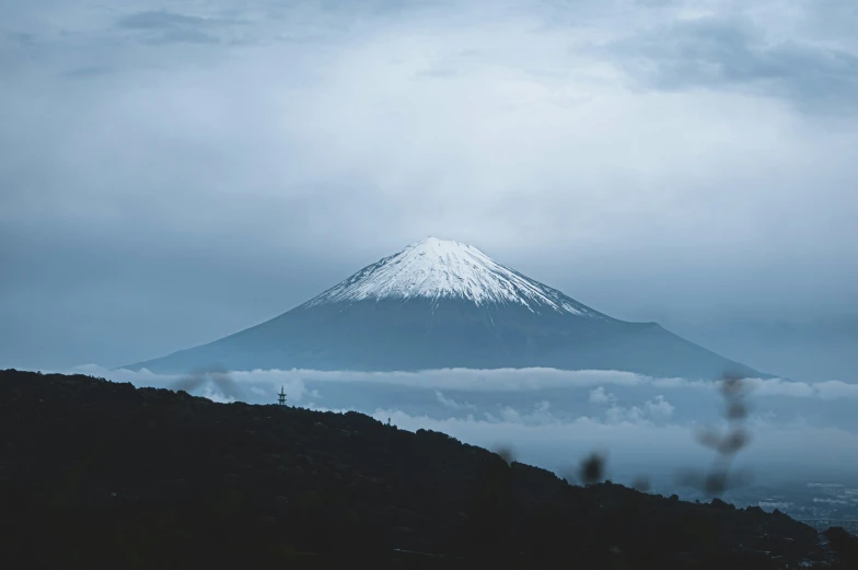 the view from a distance with the snow covered mountain behind it