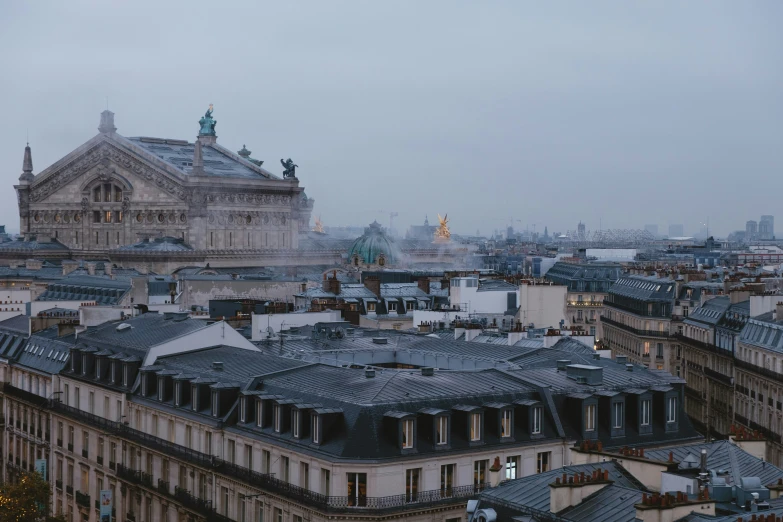 an aerial view of buildings in paris during the night