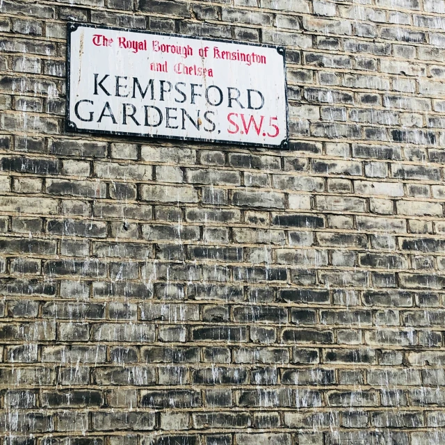 old brick wall with street signs on it