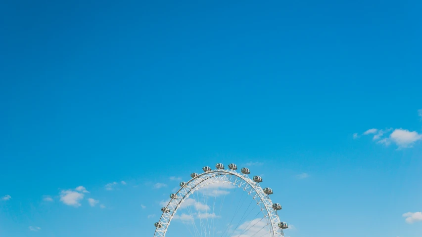 the london eye under the cloudy blue sky