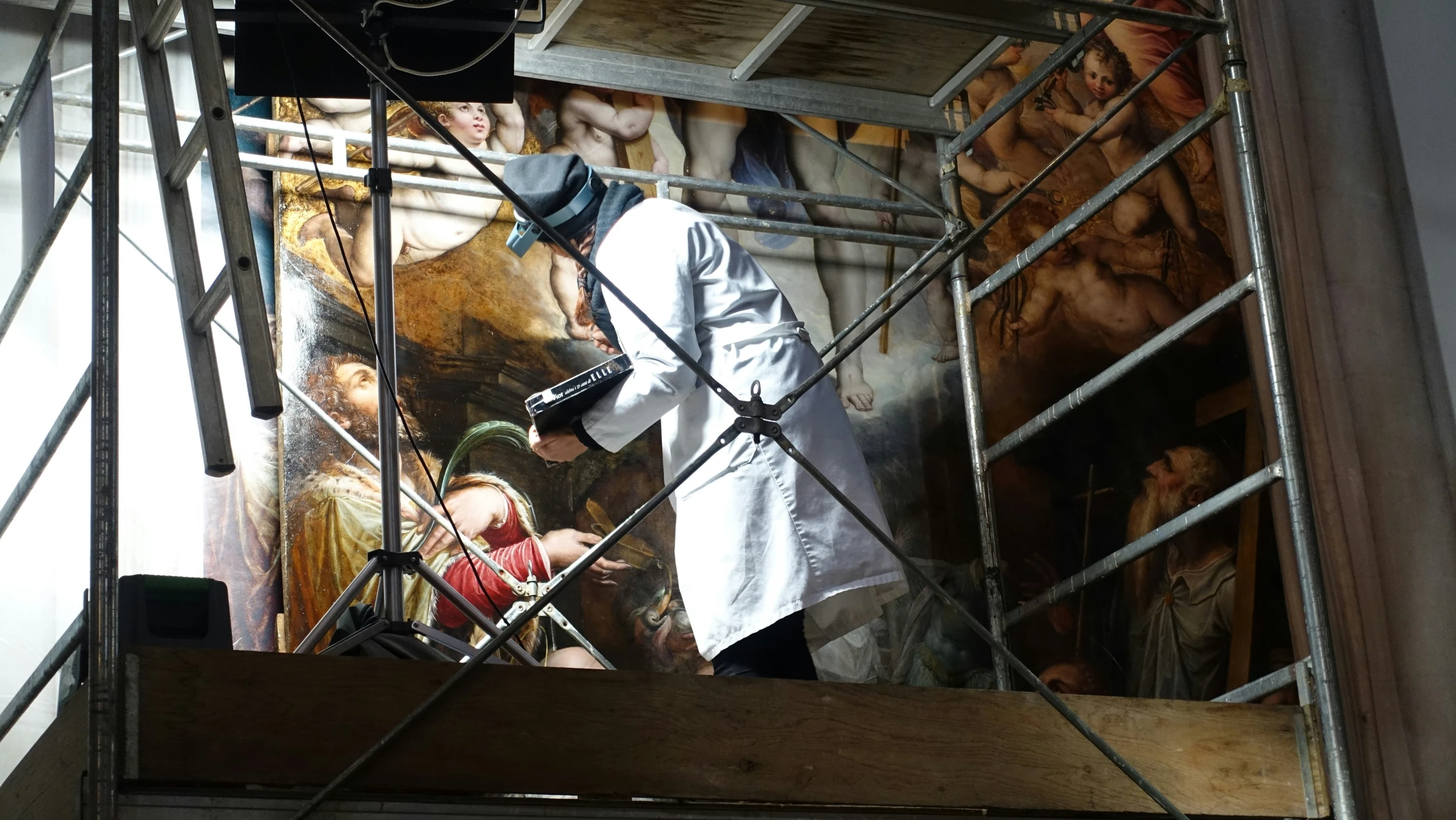 a man is standing on top of scaffolding with scissors