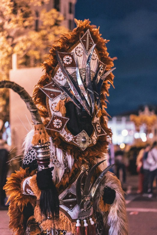 a man wearing a feathered costume walks down the street