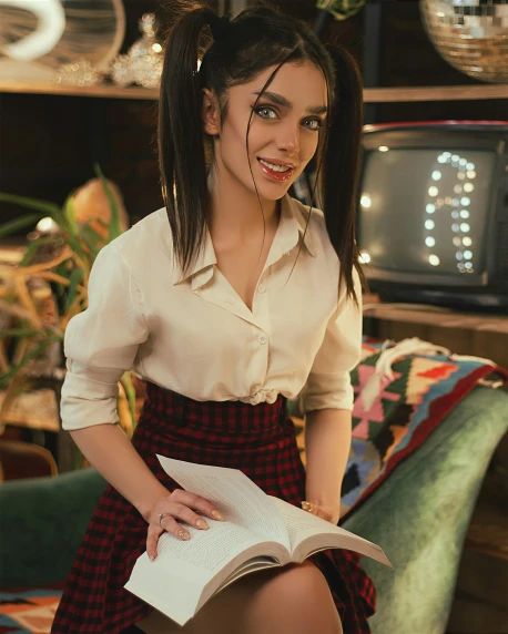 a woman in a red and black plaid skirt sitting on a green couch