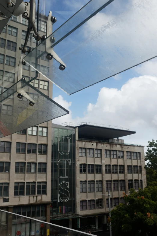 a view looking through an outside window at the city's buildings