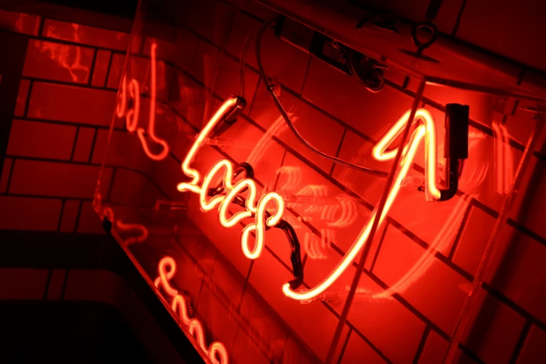 a red neon sign that says 