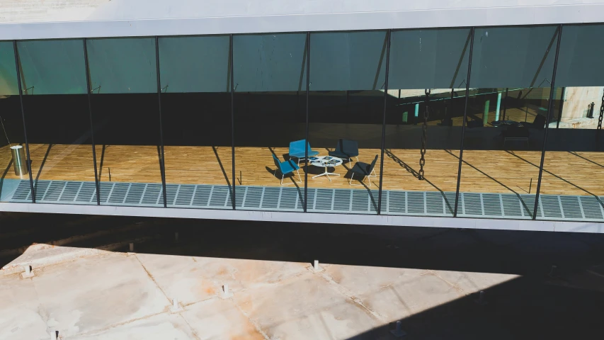 a reflection of people sitting on a bench by the water