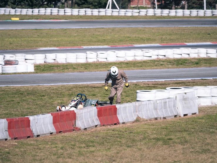 a person with a hat on and a bag on a race track