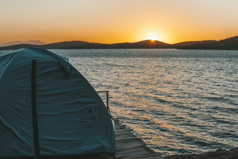 a tent on the shore near a body of water