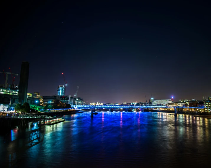 the city and the river have brightly lit bridges