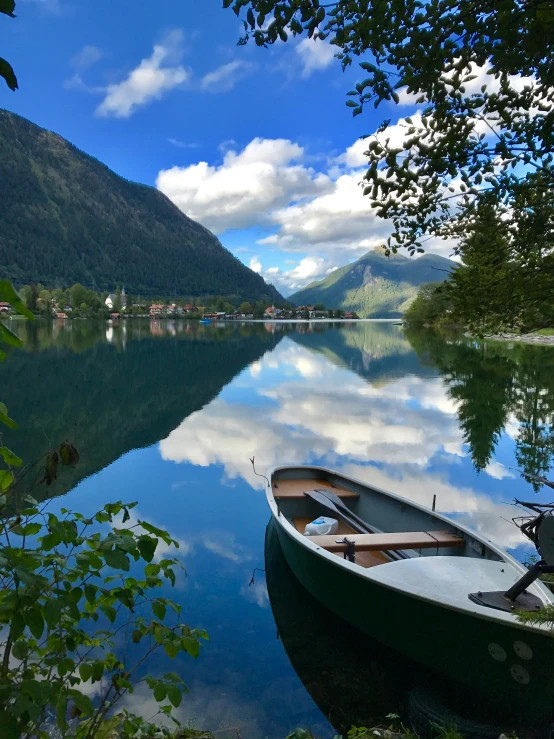 a small boat tied up next to a dock