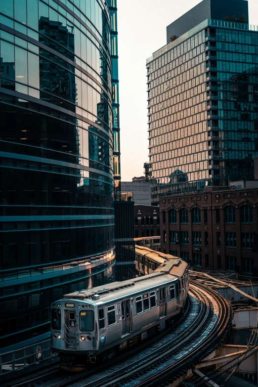 a cityscape with lots of tall buildings and a subway train on tracks