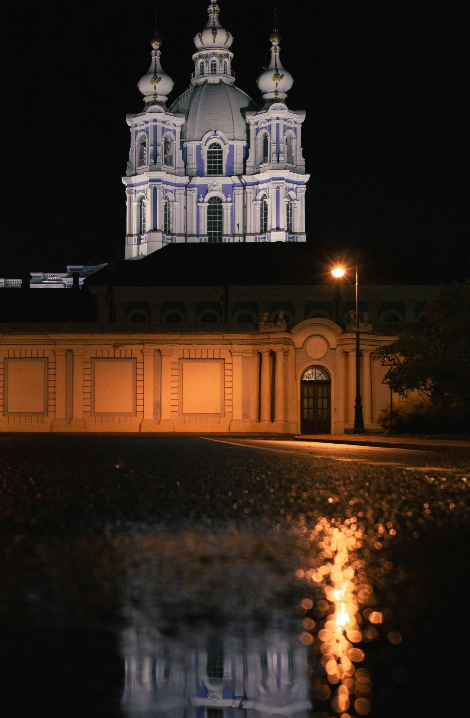 the clock tower in the background is reflected in the water