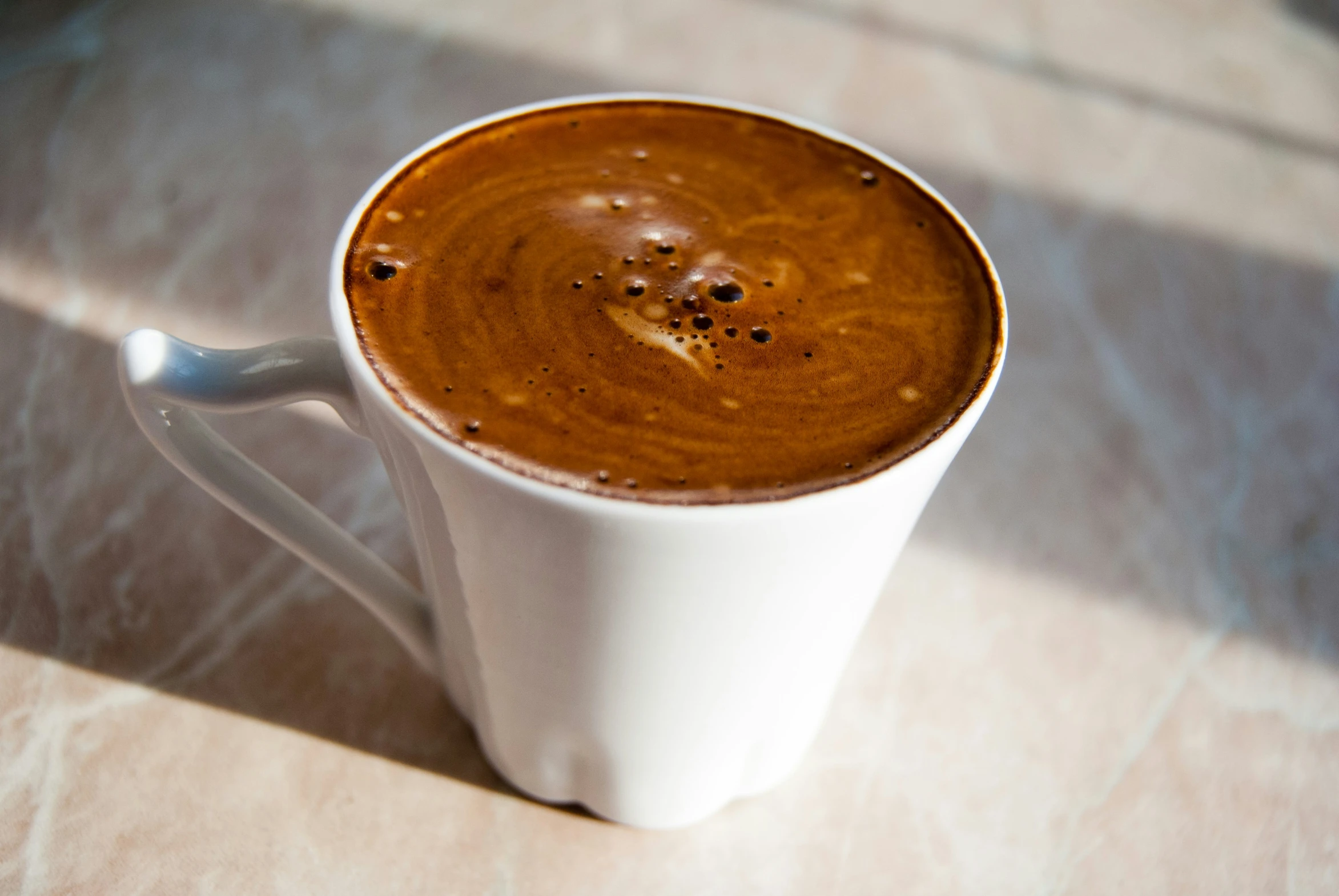 a cup of  chocolate with cinnamon sprinkles on the top
