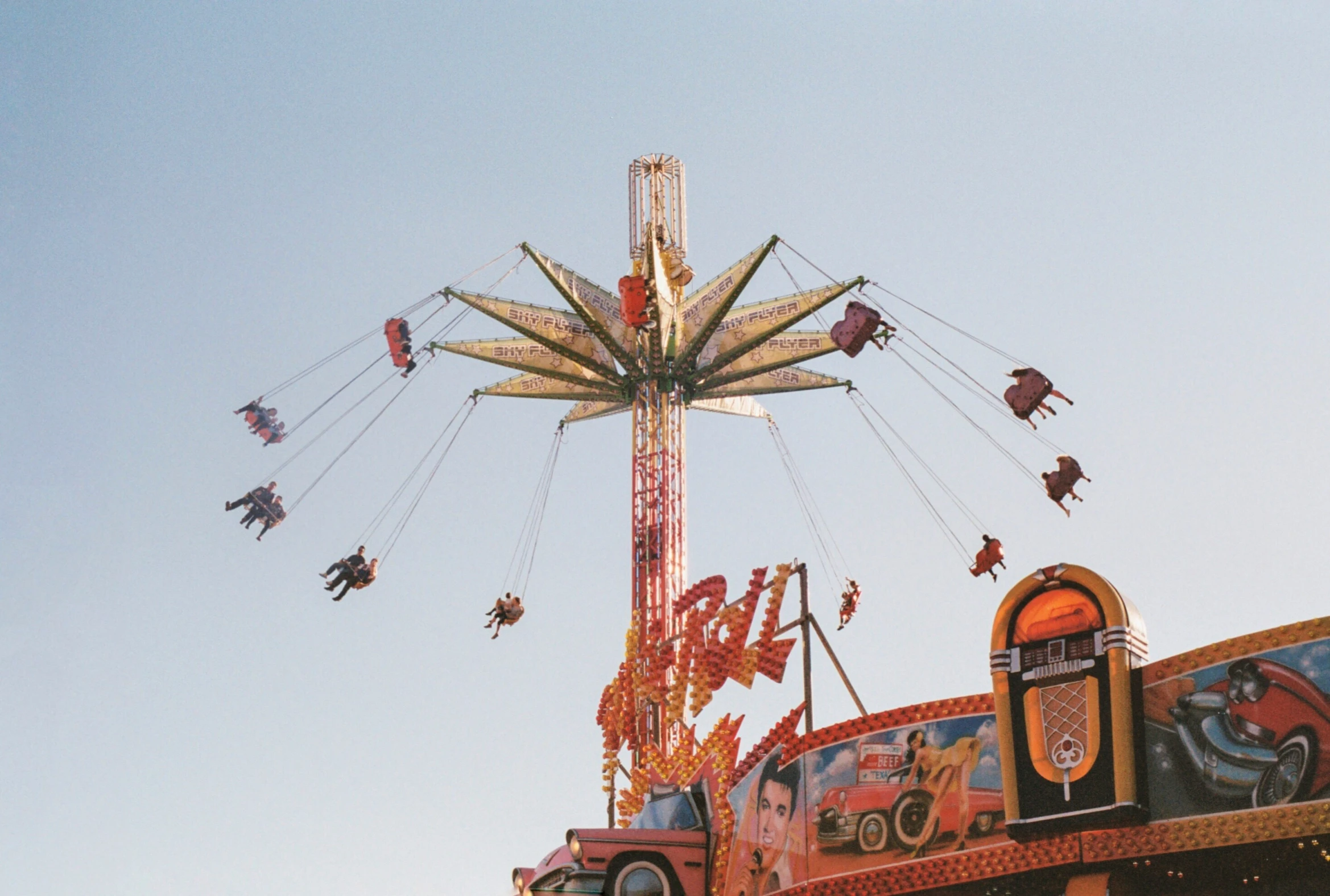 there is a large, colorful ferris wheel on the carnival ride