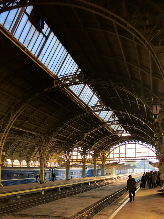 the people are standing on a platform at the train station