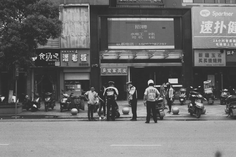 black and white po of police officers outside a building