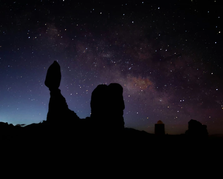 some rocks a sky some stars and the night sky