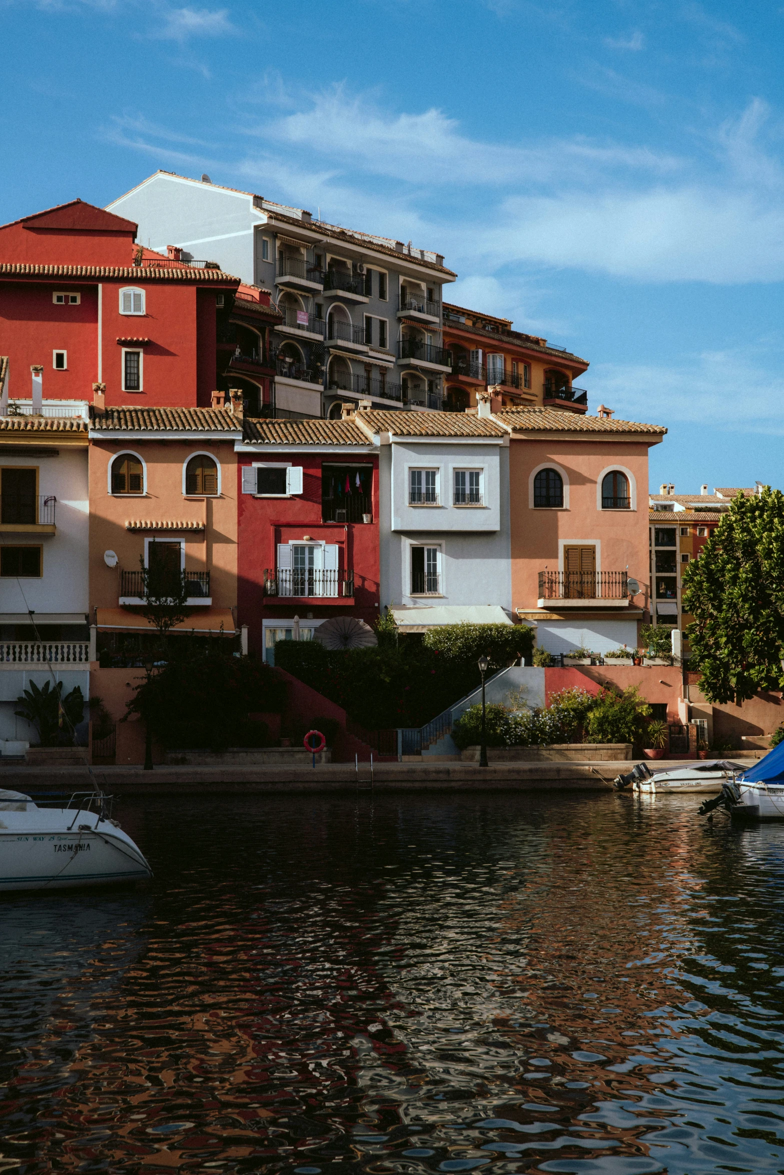 an apartment building is next to a body of water