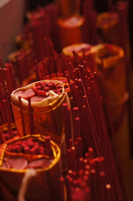 an assortment of oranges on red sticks