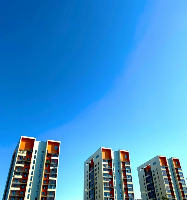 tall buildings line a beach and a bright blue sky