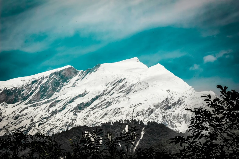 a snow - capped mountain is lit up by the sun