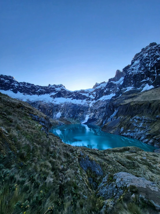 mountains and rivers in the foreground with the snow on them